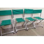 A set of four aluminium framed spectators' folding chairs,