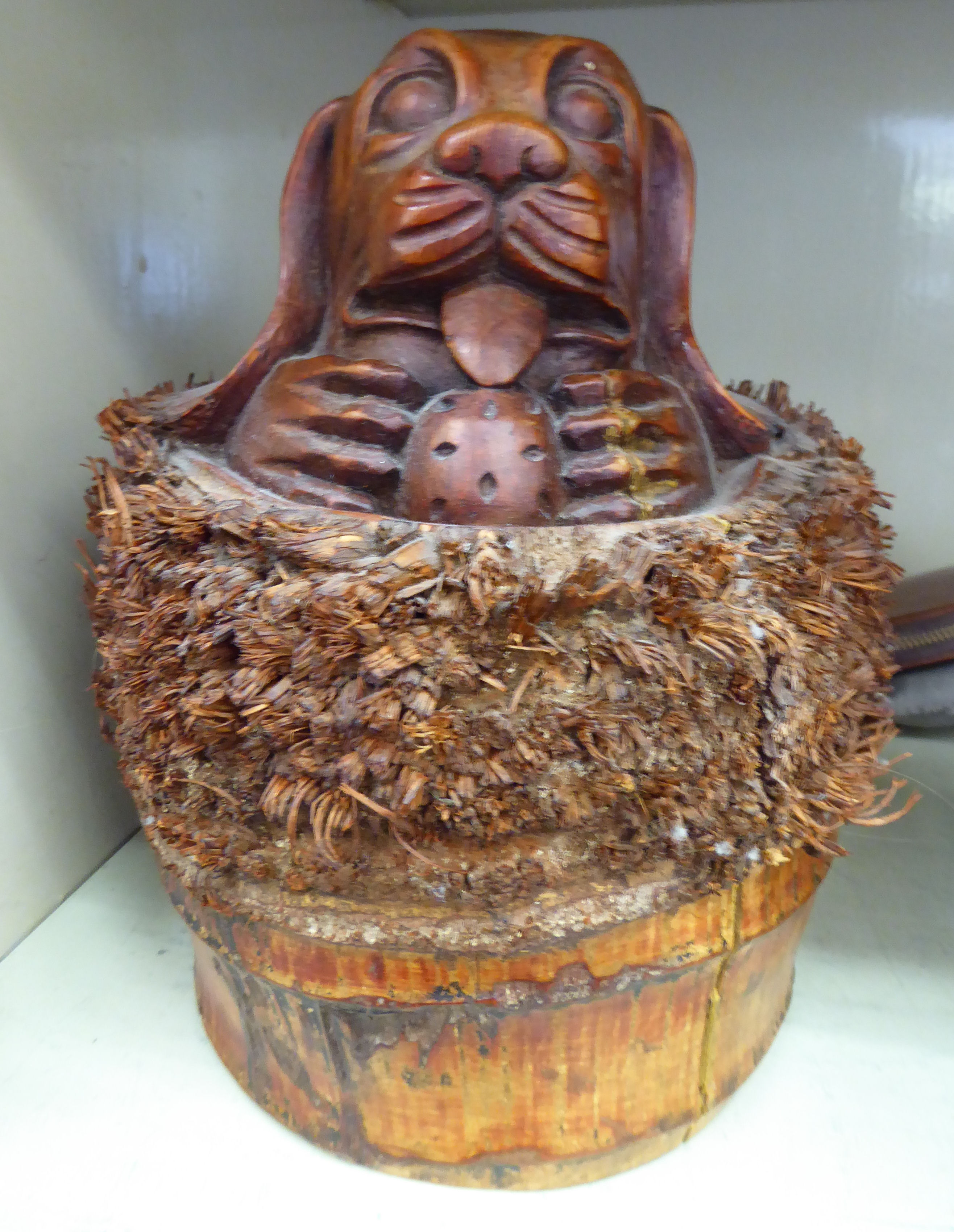A carved and stained bamboo novelty doorstop,