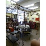 A Victorian style wrought steel terrace pergola, comprising a pair of arches,