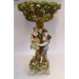 A late 19thC German porcelain table centrepiece, the elevated bowl encrusted with flora,