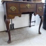 A George III stained oak lowboy with three drawers and a curved apron,