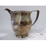 A George III silver ovoid shaped cream jug with a loop handle,