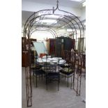A Victorian style wrought steel terrace pergola, comprising a pair of arches,