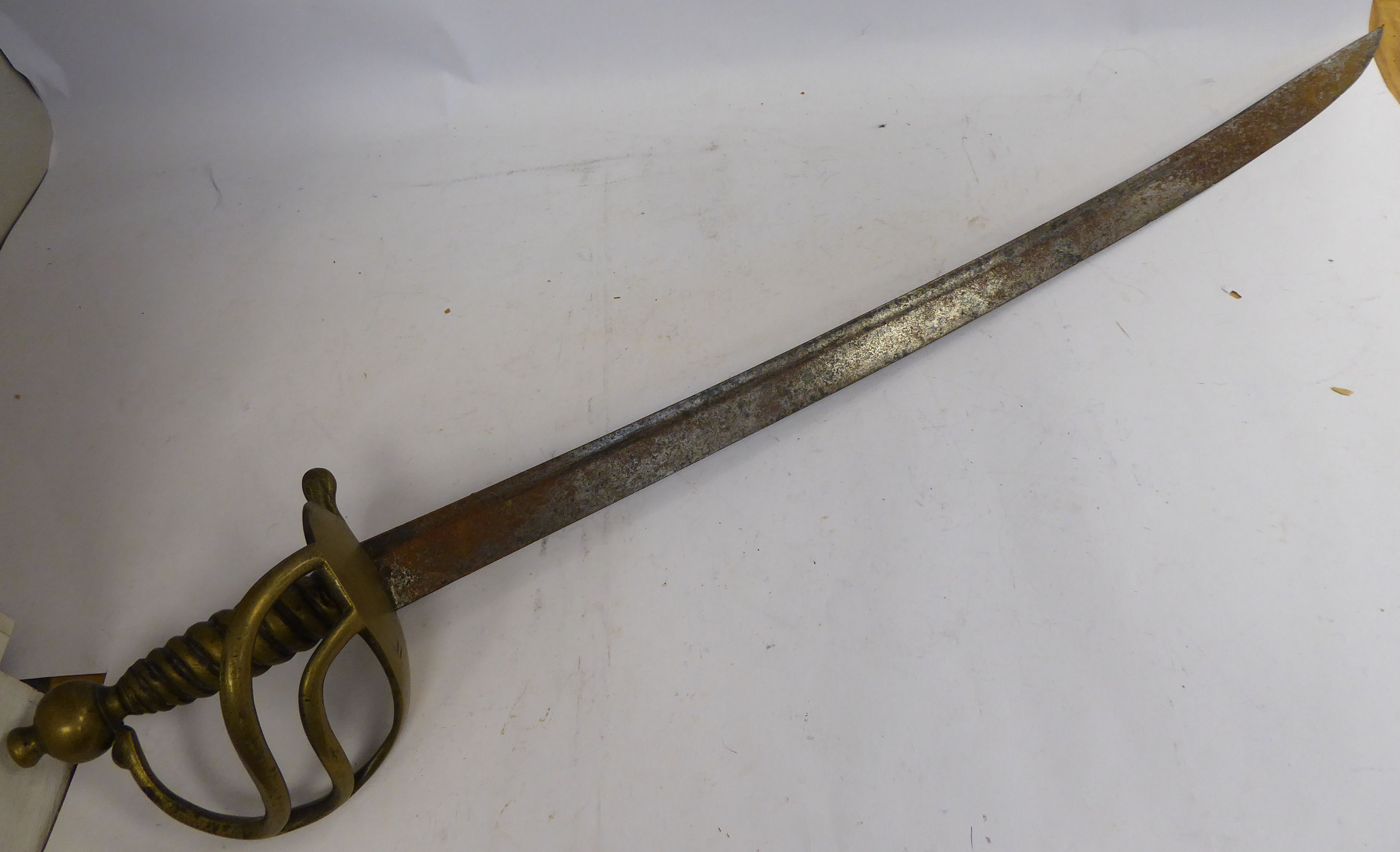 A 19thC infantry hanger, the cast brass handle with a ropetwist grip and spherical pommel,