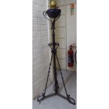 A late 19thC wrought iron standard lamp,