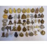 Approx fifty military cap badges and other insignia,