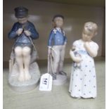 Three Royal Copenhagen porcelain figures, viz. a seated boy, whittling no.