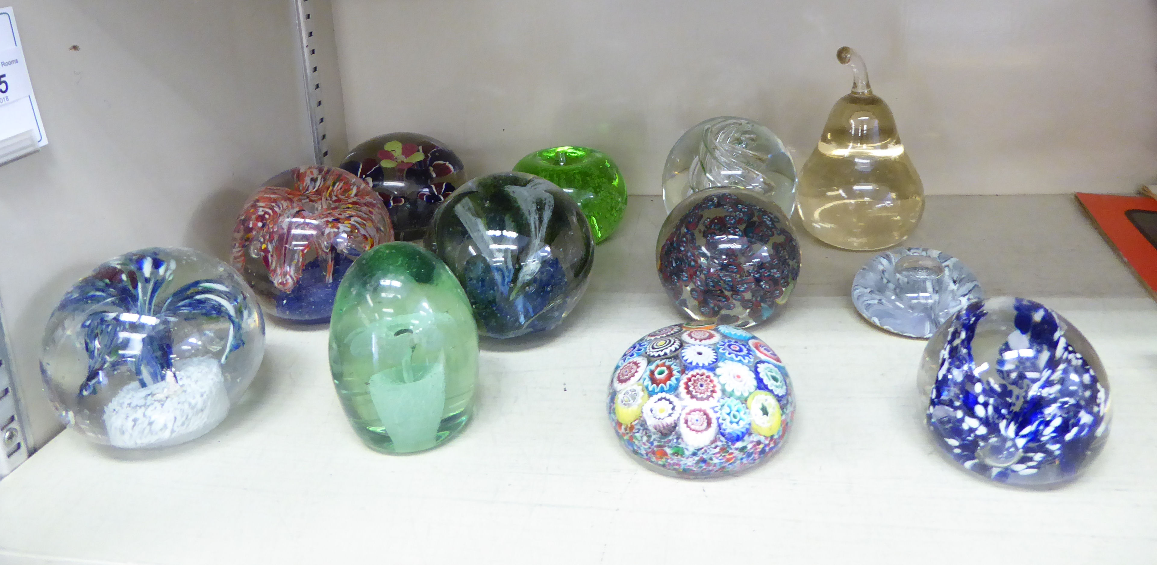 Twelve dissimilar glass paperweights: to include a Millefiori example OS10