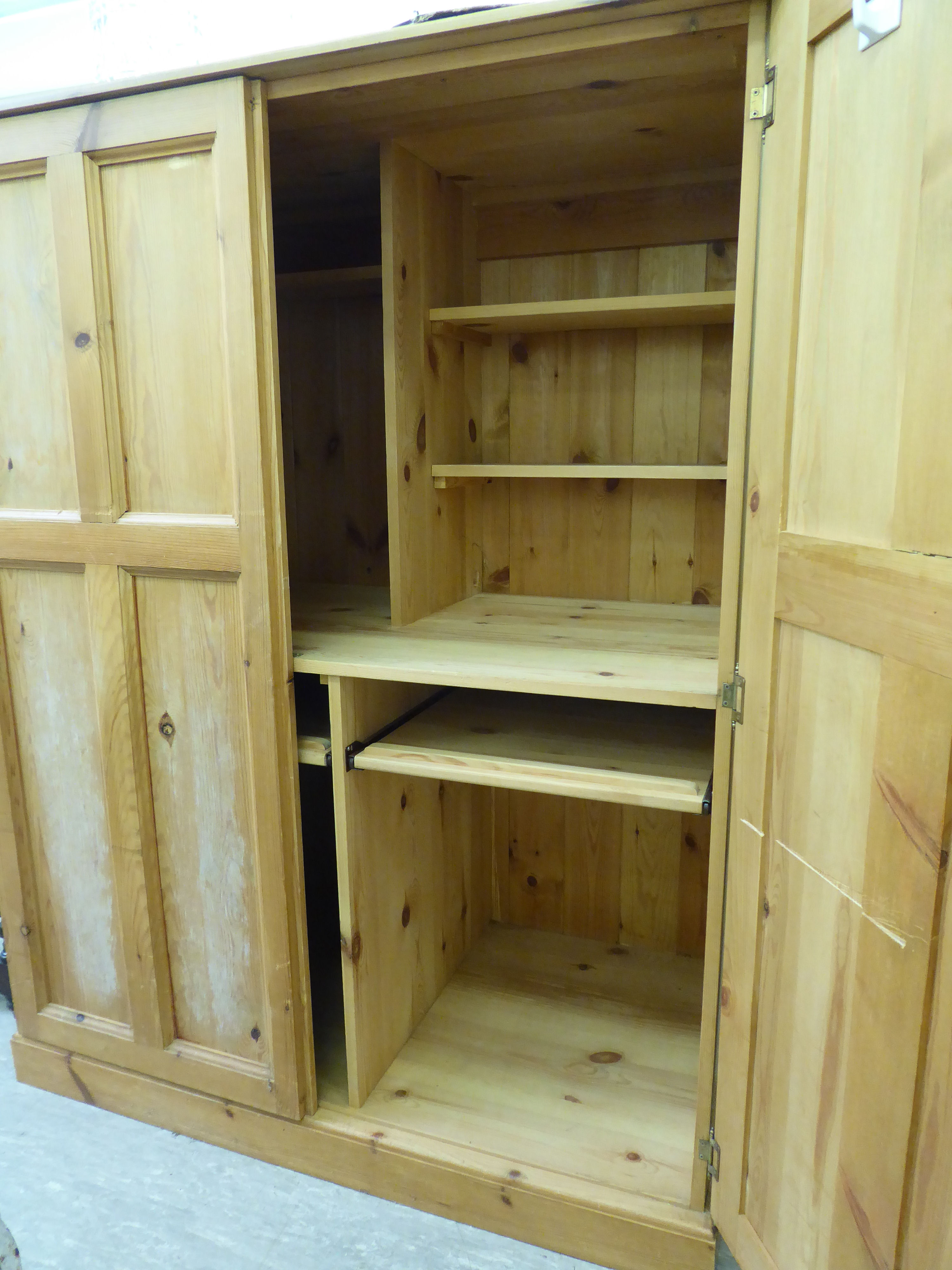 A modern stripped pine cupboard with a pair of panelled doors, - Image 2 of 2