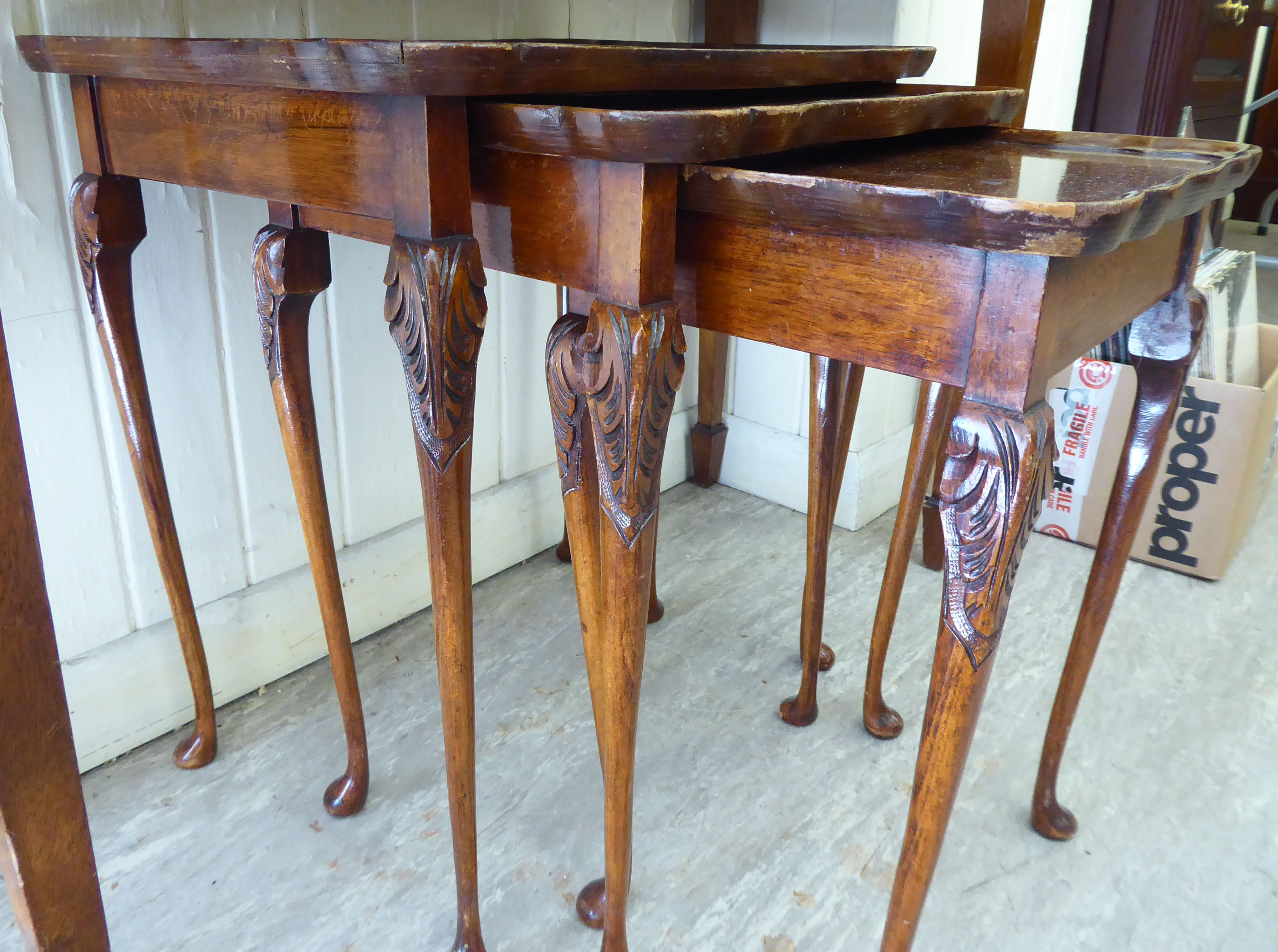 A nesting set of three 1950s walnut tray top tables,