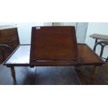 A late Victorian mahogany table top lectern with an angled centre panel, on a platform base,