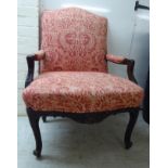 An early 20thC stained and carved beech showwood framed salon chair,