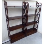 A pair of Georgian style mahogany hanging four tier shelves with uniformly fretworked sides,