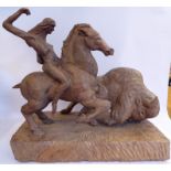 An early 20thC carved wooden sculpture, a Red Indian horseman chasing a bison,