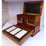 An early 20thC light oak desktop stationery cabinet with straight sides, iron flank handles,