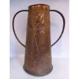 An early 20thC Newlyn inspired spot-hammered and embossed copper vase of tapered cylindrical form