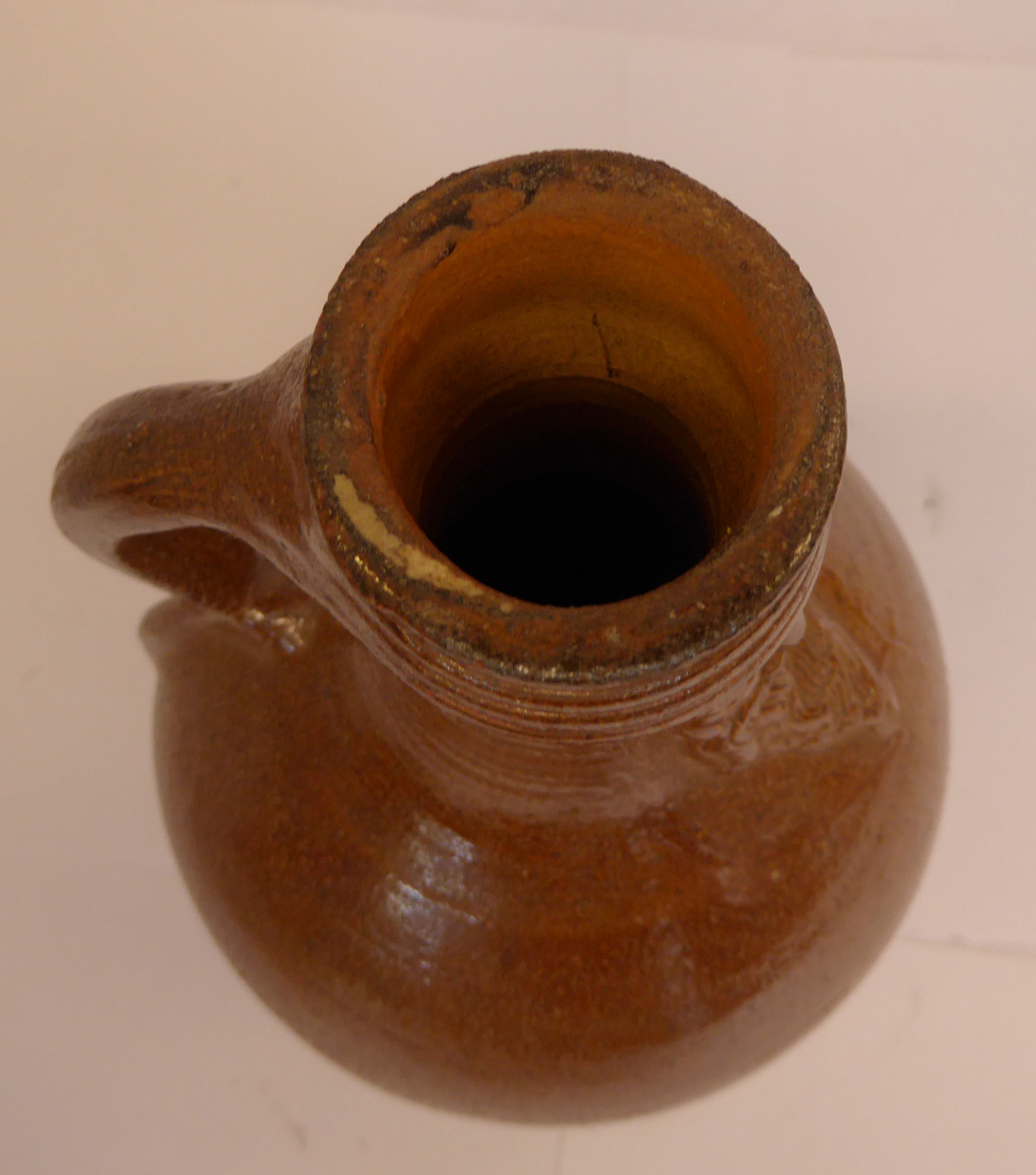 An 'antique' Continental salt glazed bellarmine of ovoid form with a strap handle bears an - Image 5 of 6
