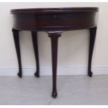 A late 18thC mahogany demi-lune tea table, the double hinged, foldover top enclosing a lockable,