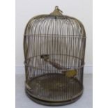 A late 19thC lacquered brass wire bell design parrot's cage with an integral base and feeders on