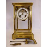 An early 20thC lacquered brass cased four glass mantel clock,