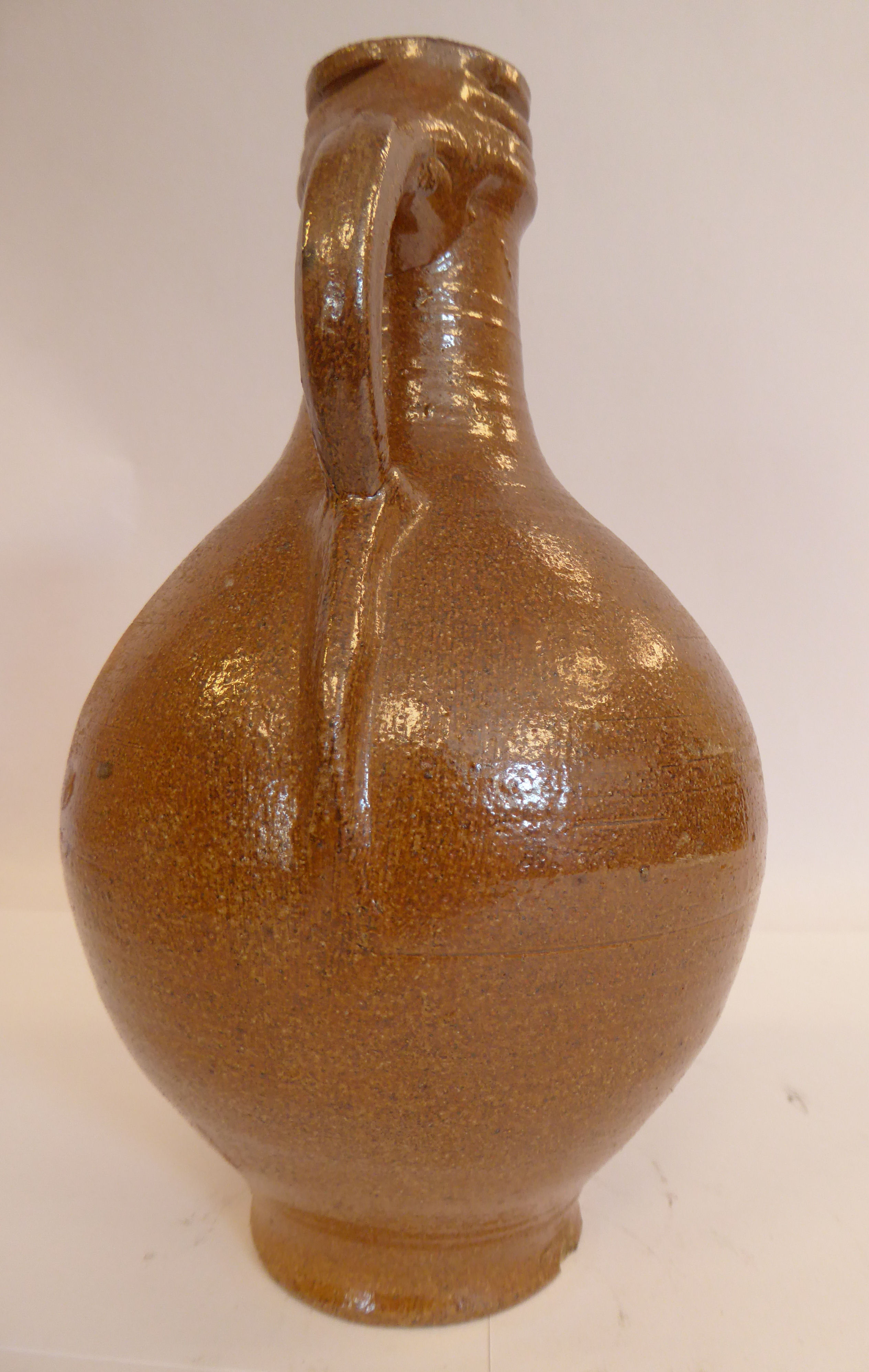 An 'antique' Continental salt glazed bellarmine of ovoid form with a strap handle bears an - Image 3 of 6