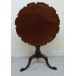A George III mahogany tip-top table with a raised, piecrust border,