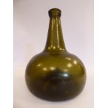 A late 18th/early 19thC semi-opaque green glass wine bottle of squat,