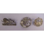 Three silver military cap badges, viz. The Essex Regt.