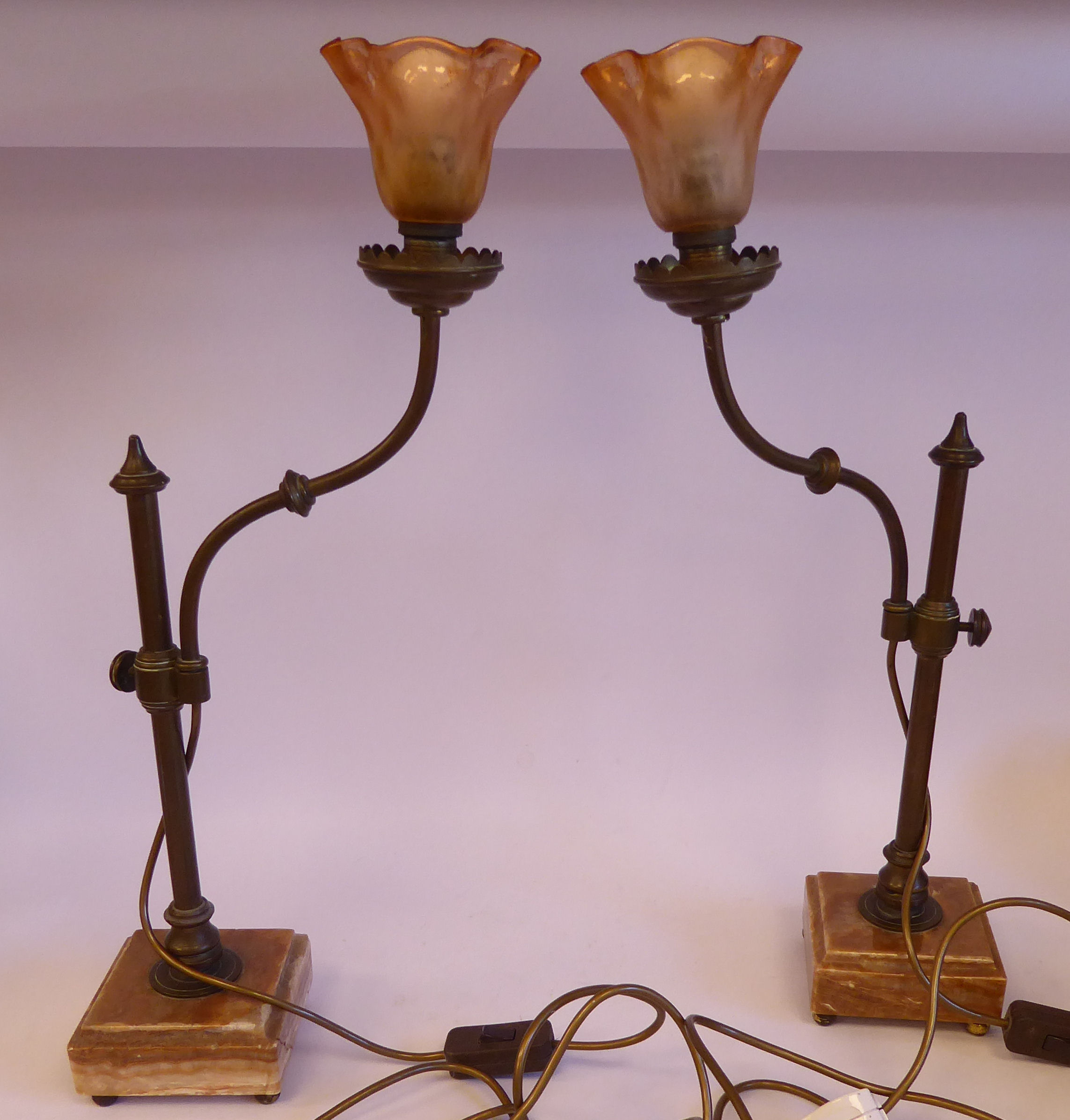 A pair of early 20thC French bronze table lamps, each with an adjustable tubular stem,