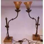 A pair of early 20thC French bronze table lamps, each with an adjustable tubular stem,