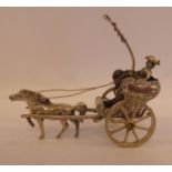 A Dutch silver coloured metal miniature model, a figure wearing a tricorn hat, driving a horse,