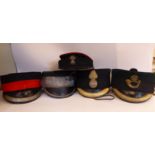 Five similar 'station master' style military peaked caps,