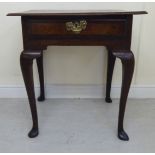 An early 19thC crossbanded mahogany and oak side table with an overhanging top and frieze drawer,