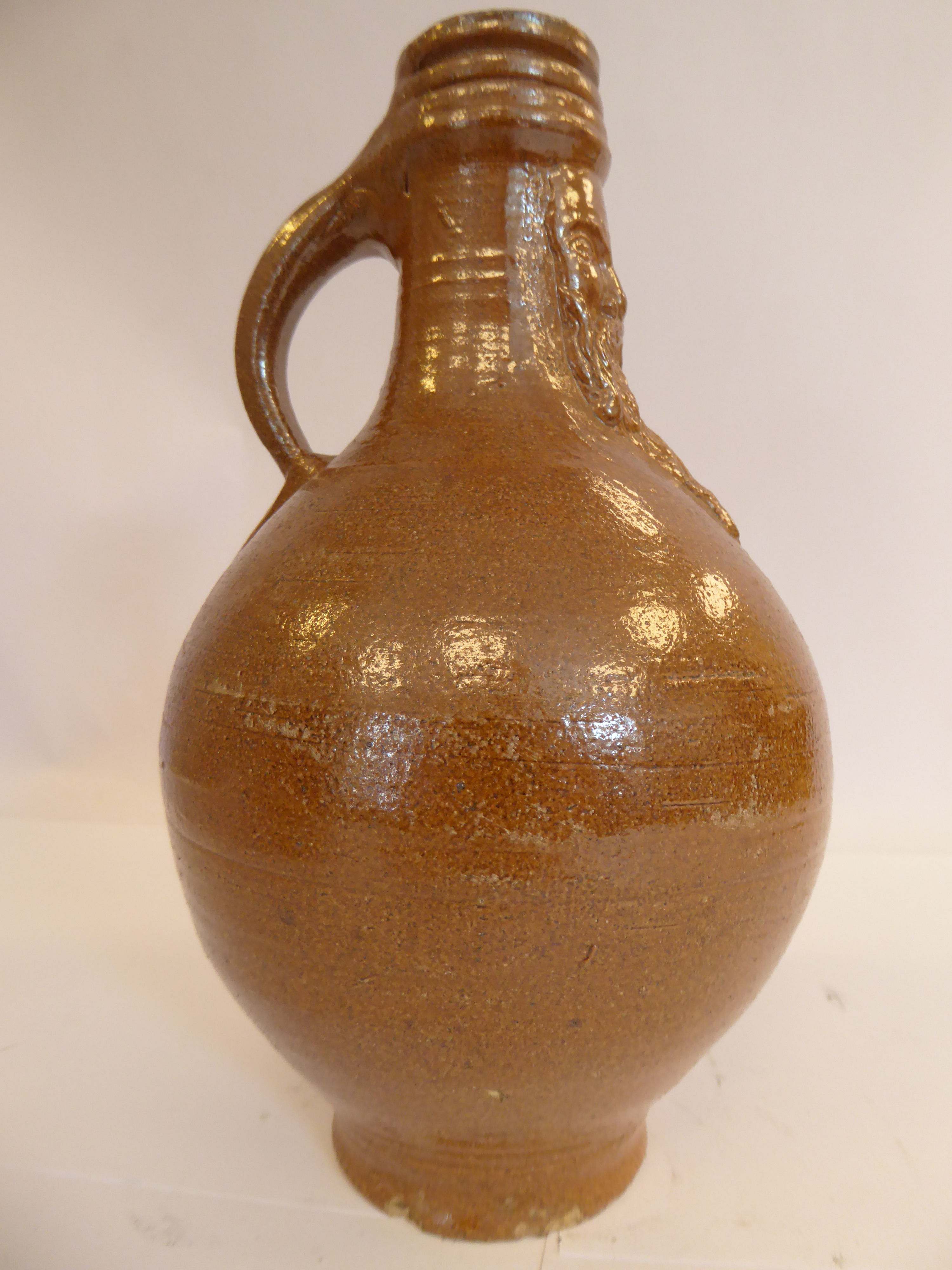 An 'antique' Continental salt glazed bellarmine of ovoid form with a strap handle bears an - Image 4 of 6