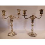 A pair of Georgian style two-part loaded silver table candelabra of hexagonal outline,