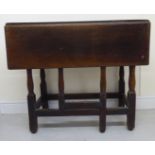 An early/mid 18thC country made oak side table with a planked top and single fall flap,