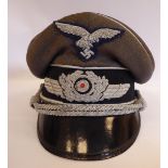 A World War II German Luftwaffe peaked cap with a braided eagle and swastika