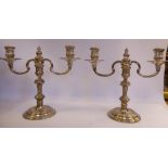 A pair of Georgian style loaded silver, two-part table candelabra,