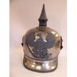 A German military spiked steel helmet with an FR eagle emblem,