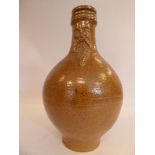 An 'antique' Continental salt glazed bellarmine of ovoid form with a strap handle bears an