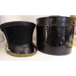 An early 19thC style wide topped black military shako with a brass chain link chinstrap and a