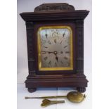 A late 19thC mahogany cased bracket clock, carved with bellflowers and garlands,