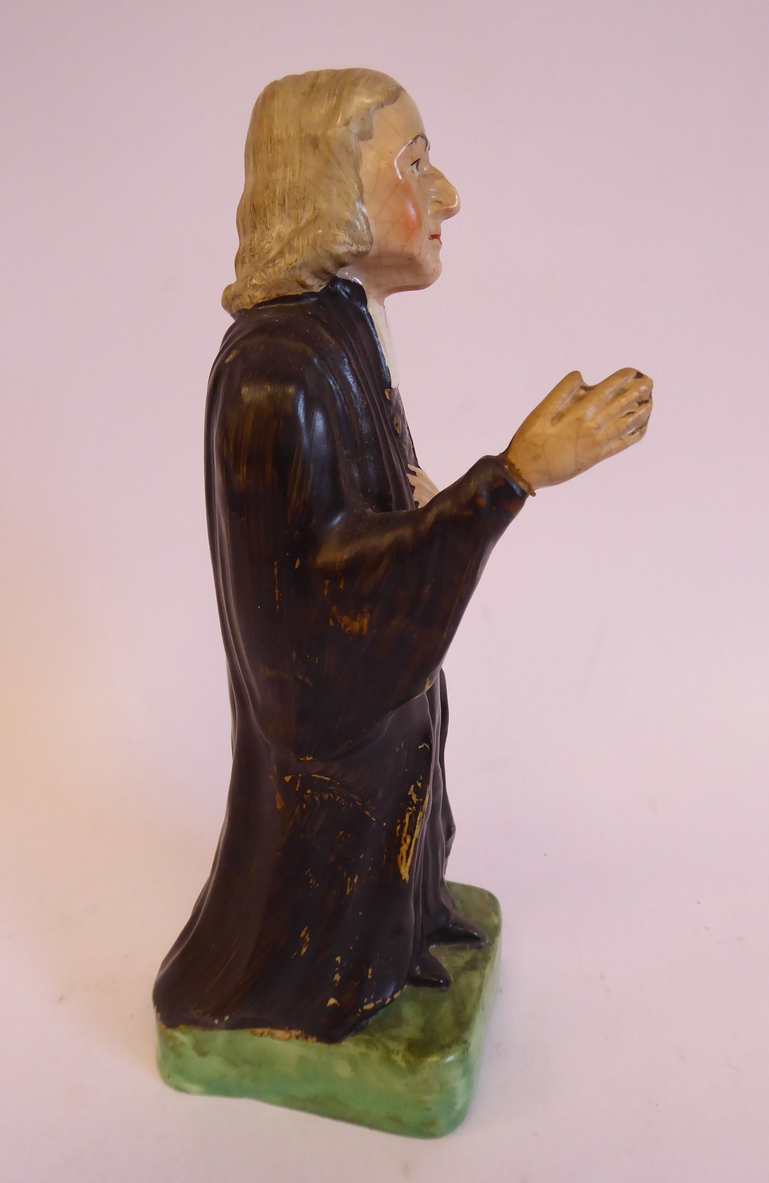 A 19thC Staffordshire pottery figure, John Wesley, wearing a black surplus and white cravat, - Image 3 of 5