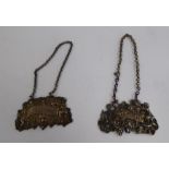 A matched pair of early 19thC silver wine labels, Sherry and Brandy, cast with cherubic figures,