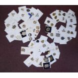 Approximately fifty-five military cap badges and other insignia,