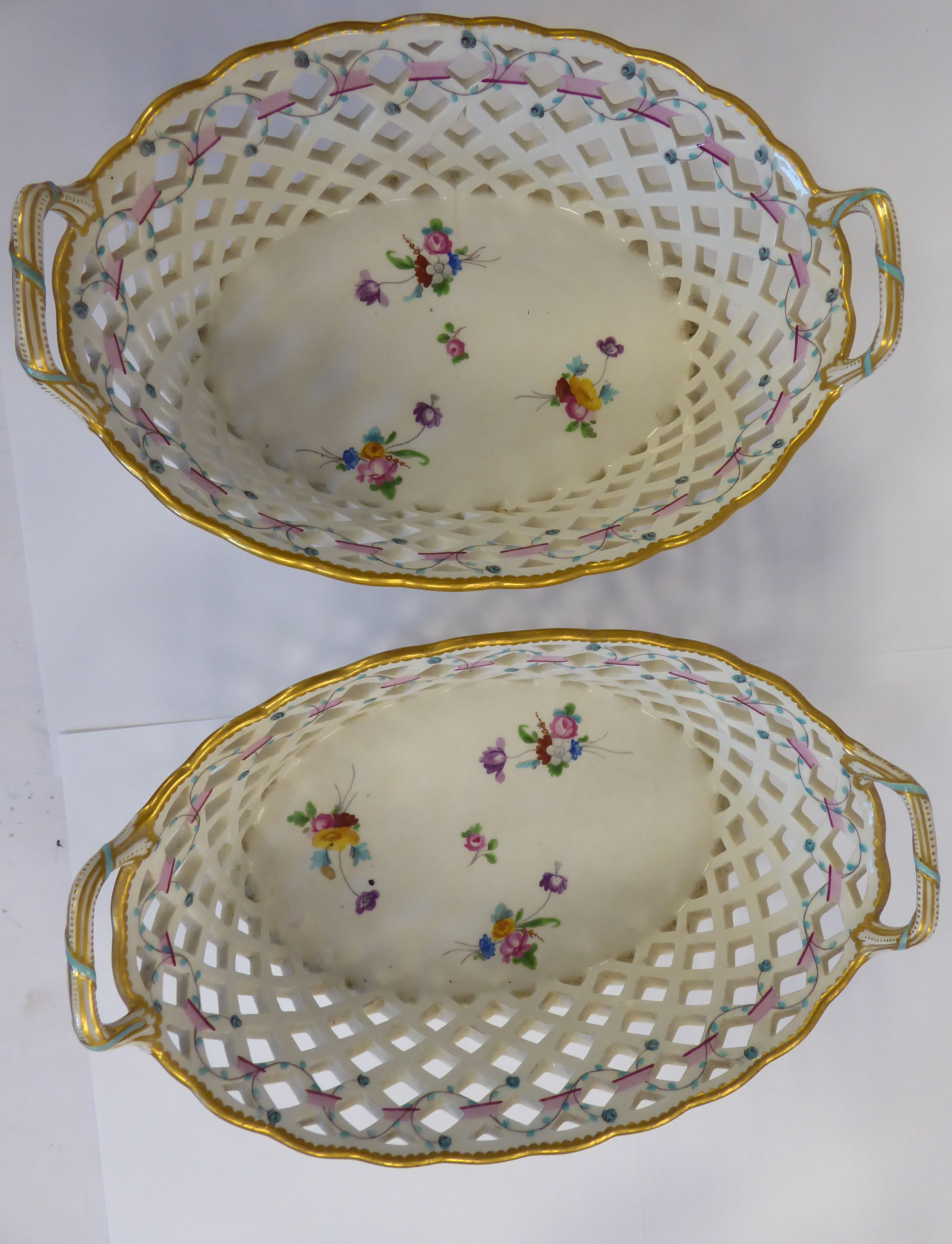 A pair of early 19thC Derby porcelain oval baskets with flared,