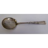A Danish HCF silver jam spoon with a shallow circular bowl, on a decoratively cast,