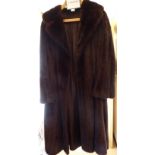 A lady's black mink knee-length satin lined, lapelled fur coat approx.