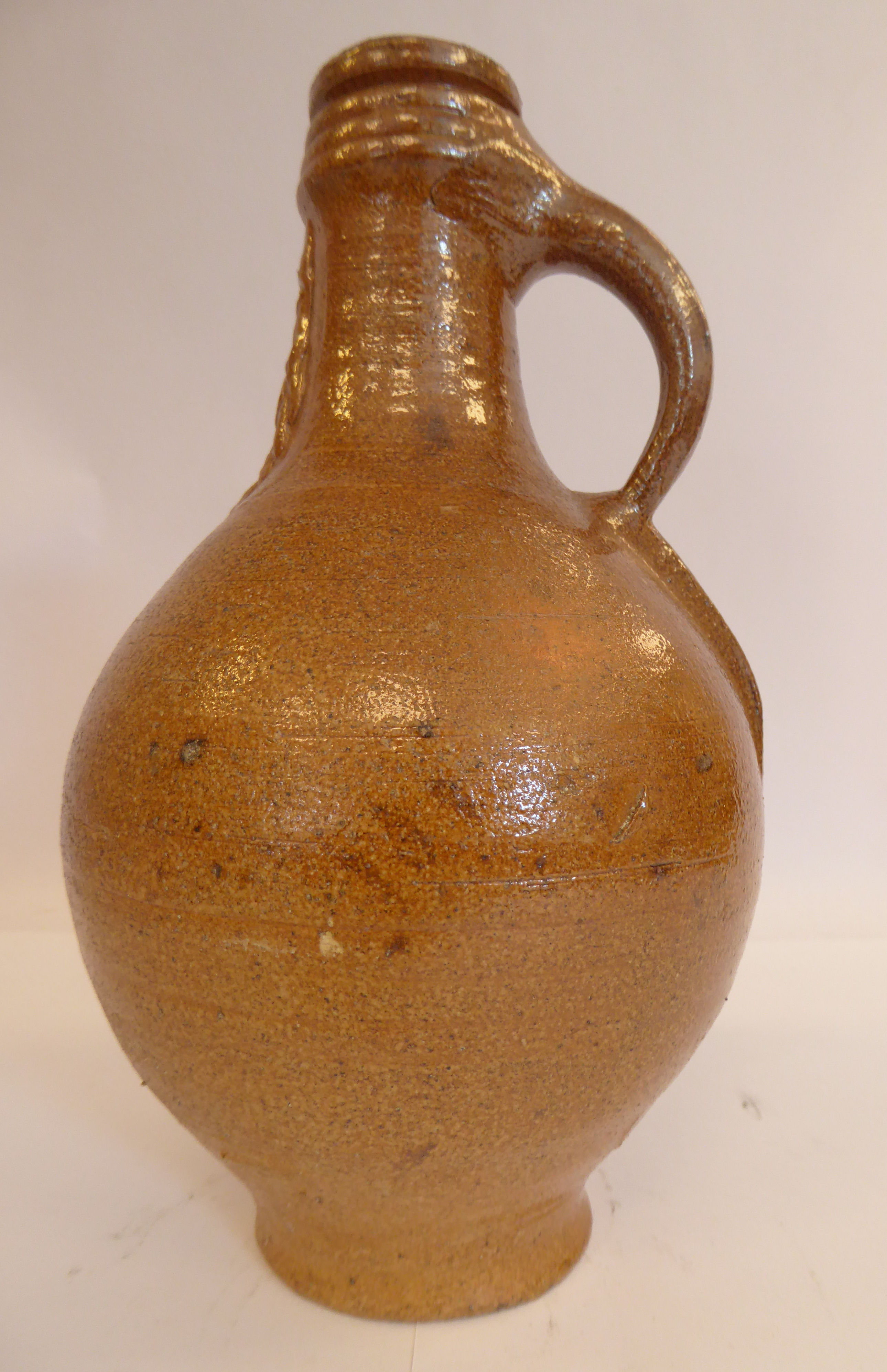 An 'antique' Continental salt glazed bellarmine of ovoid form with a strap handle bears an - Image 2 of 6