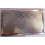 A bi-coloured silver folding cigarette case with lined and engine turned decoration,